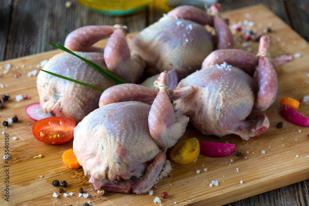 Fotografie Raw quails, onions, garlic, lettuce, olive oil, carrot...