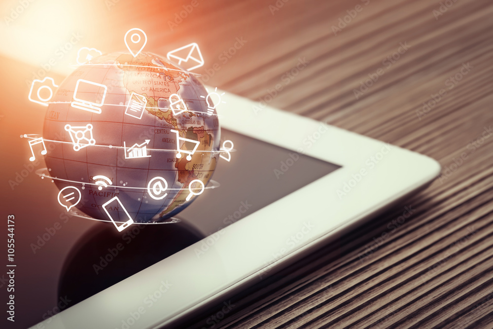 media icons fly around globe on tablet computer media icons fly around globe on tablet computer