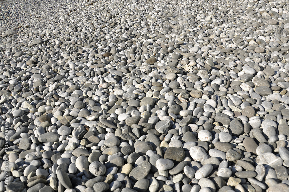 Background image of gray pebbles on a beach Background image of gray pebbles on a beach