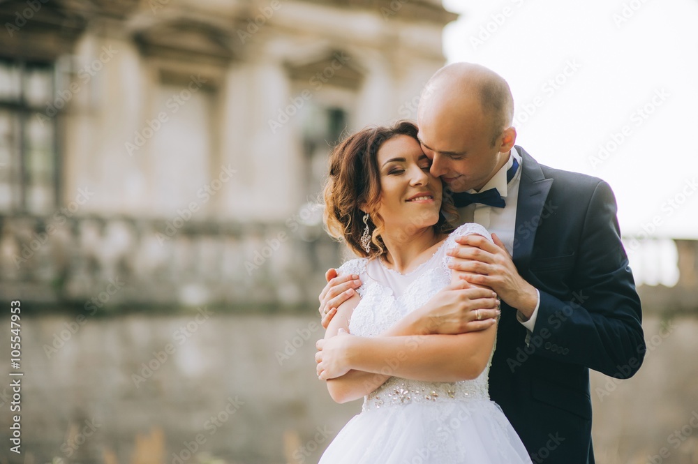 Naklejka premium couple after wedding in tne park near the castle