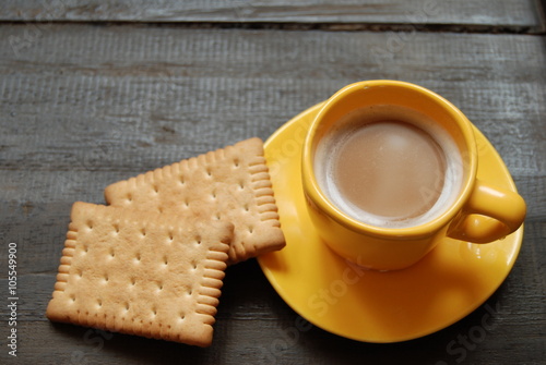 Instant Hot Coffee with plain biscuits on wooden background. Close-up, view from above.