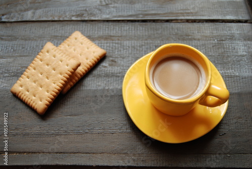 Instant Hot Coffee with plain biscuits on wooden background. Close-up, view from above.