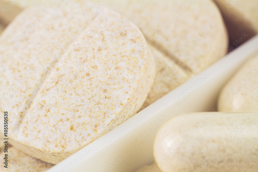 Mixed natural food supplement pills, macro image, selective focus Mixed natural food supplement pills, macro image, selective focus