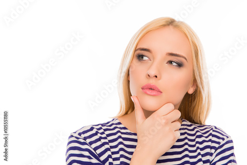 Portrait of minded woman touching her chin and dreaming