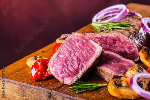 Grill beef steak. Portions thick beef juicy sirloin steaks on grill teflon pan or old wooden board.