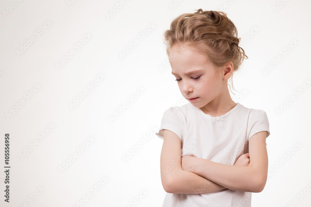 Cute teen girl angry frowns, studio portrait isolated on white background Cute teen girl angry frowns, studio portrait isolated on white background