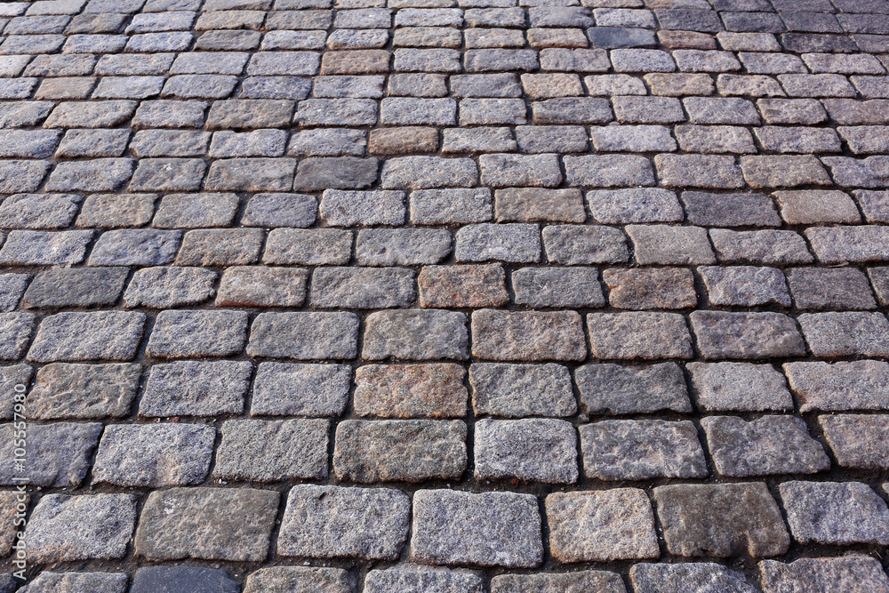 Granite cobblestoned pavement background Granite cobblestoned pavement background