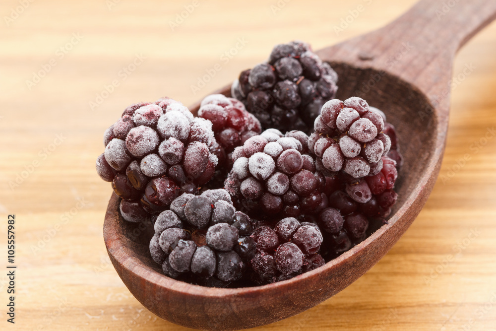 Macro view on frozen Blackberry fruits in spoon Macro view on frozen Blackberry fruits in spoon
