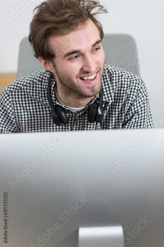 Man looking at a computer screen, thinking about the job at hand