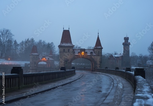 Picture of the old historic and vintage stone dam from 19th century in the sunset in the winter. Dam with pitoresque watching towers and gate named Les Kralovstvi in Czech Republic, Europe.