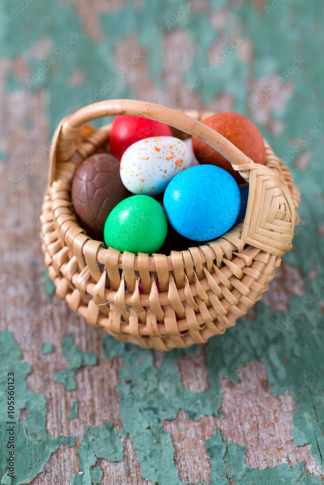 Easter candy eggs on old wooden surface Easter candy eggs on old wooden surface