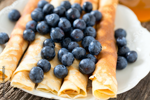 pancakes with blueberries on wooden surface