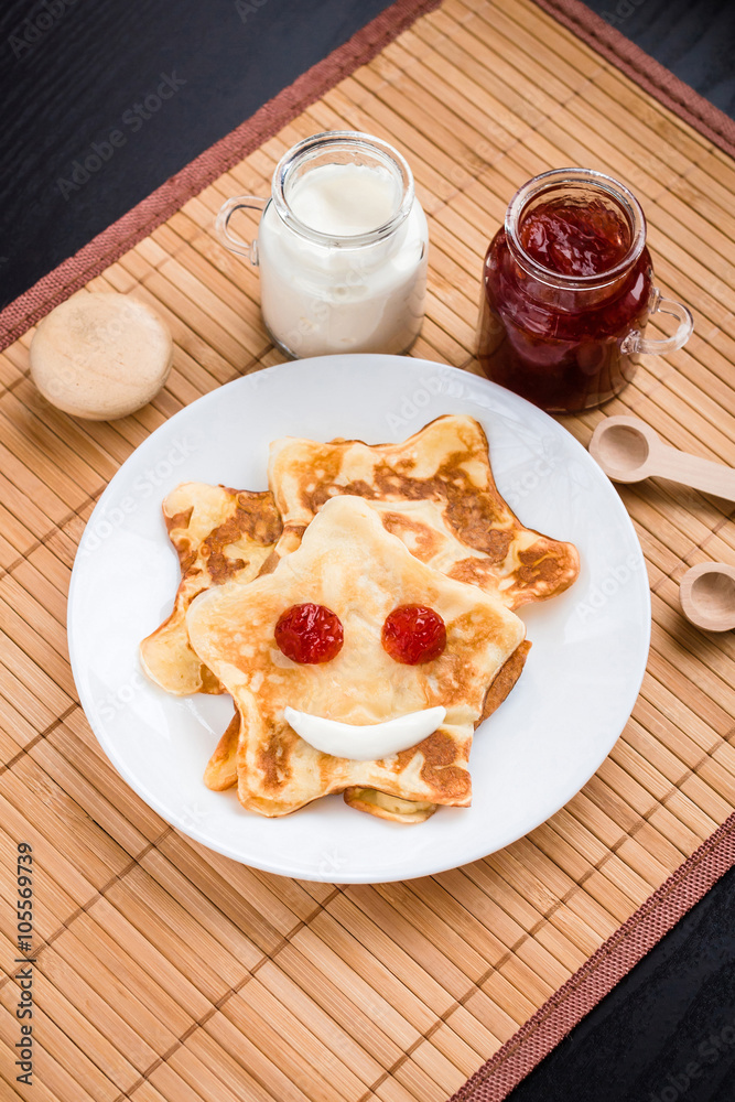 Kids breakfast- pancakes in the shape of stars with jam and sour cream Kids breakfast- pancakes in the shape of stars with jam and sour cream