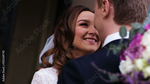 Beautiful young couple just entered from the church where they officially became wife and husband and promised to be together for the rest of theirs life.