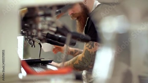 Barista making coffee in coffeeshop. Close up. Slow motion