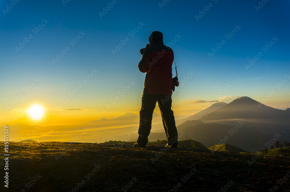 silhouette photographer during sunrise