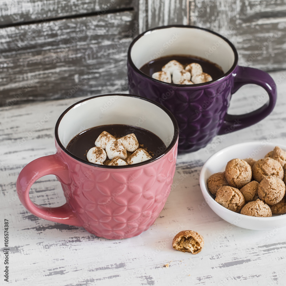 Hot chocolate with marshmallows, cinnamon and almond cookies on a wooden rustic background. Vintage style Hot chocolate with marshmallows, cinnamon and almond cookies on a wooden rustic background. Vintage style