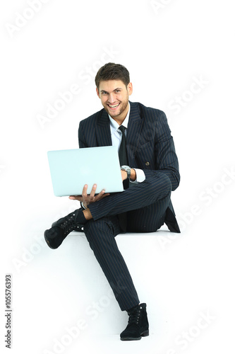 handsome young business man sitting on a white modern chair © ASDF