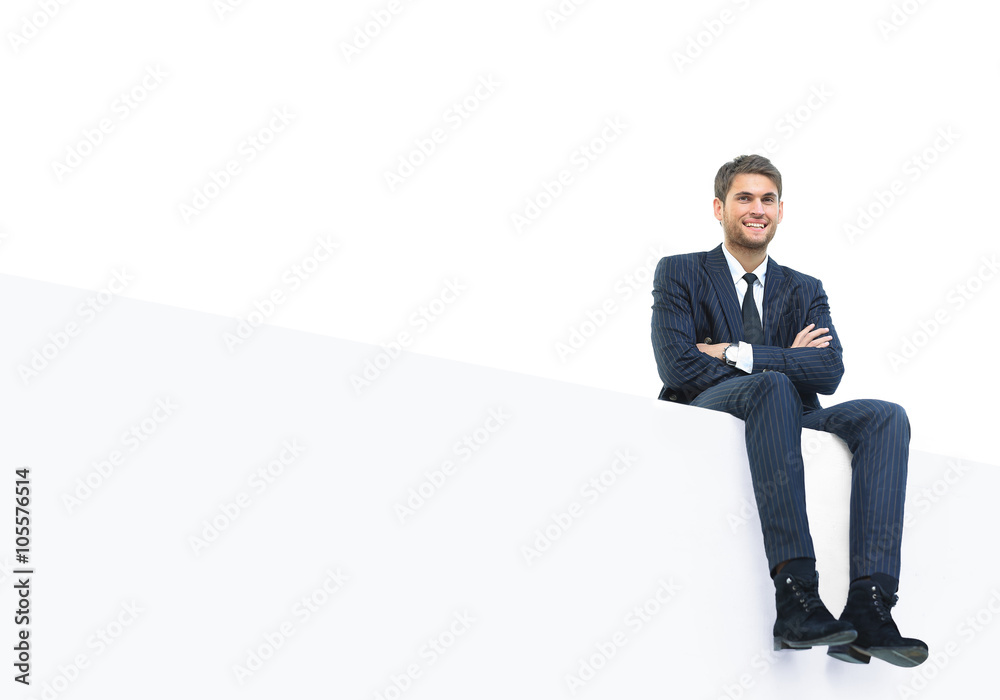 handsome young business man sitting on a white top handsome young business man sitting on a white top