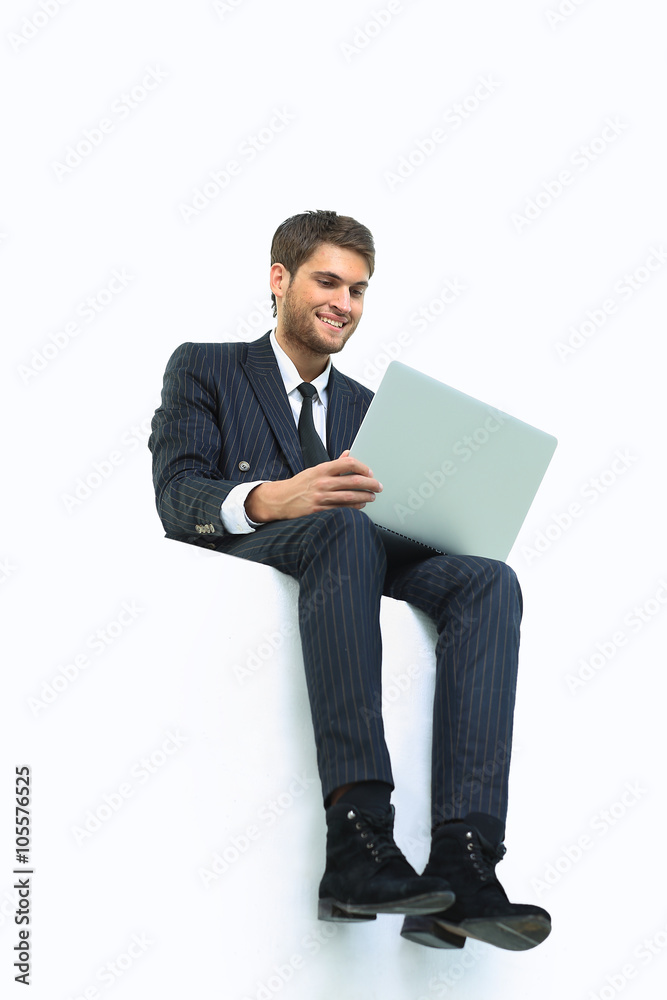 handsome young business man sitting on a white top handsome young business man sitting on a white top