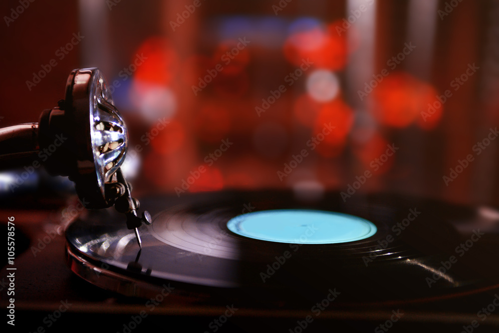 Turntable with vinyl record on dark blurred background Turntable with vinyl record on dark blurred background