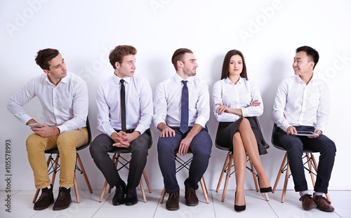 Seated young men looking at...