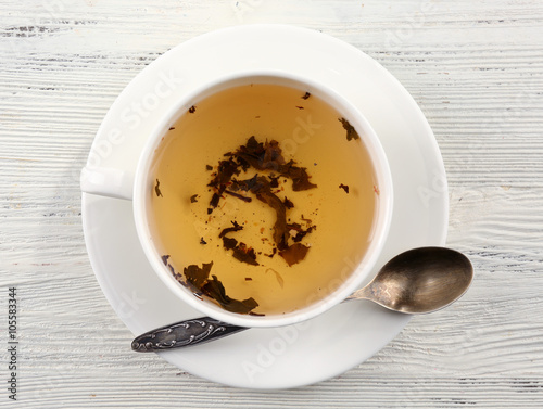 Cup of tea on white table, top view