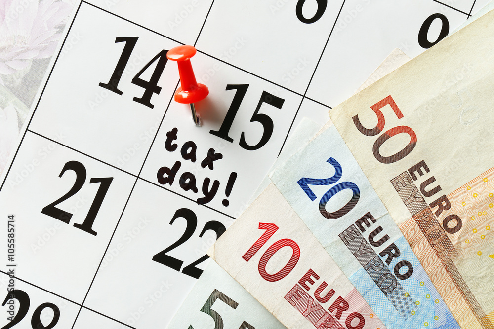 Tax day in the calendar with euro bills, close up Tax day in the calendar with euro bills, close up