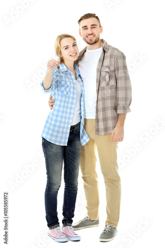 Happy young couple with key...