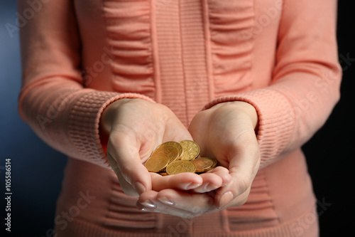 Female hands holding a handful of euro coins, close up