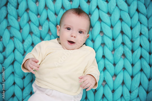 Lovely baby on knitted turq...