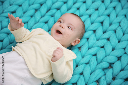 Lovely baby on knitted turq...