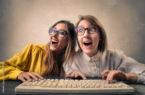 Excited friends using a pc