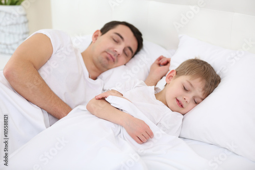 Father and son sleeping in ...