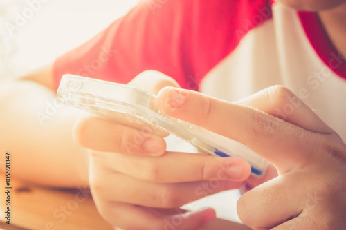 close up hand of kid using smart phone
