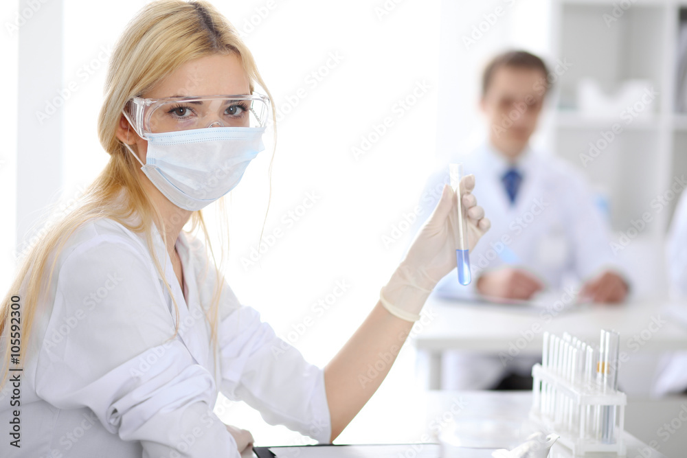 Scientific research team with clear solution in laboratory Scientific research team with clear solution in laboratory