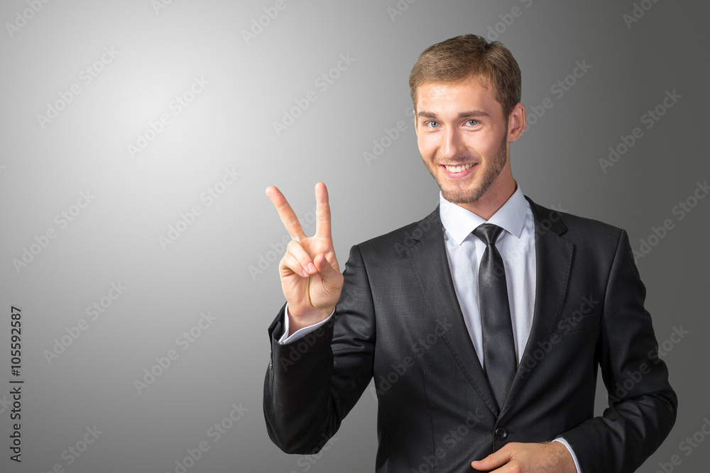 Young Businessman showing victory sign Young Businessman showing victory sign