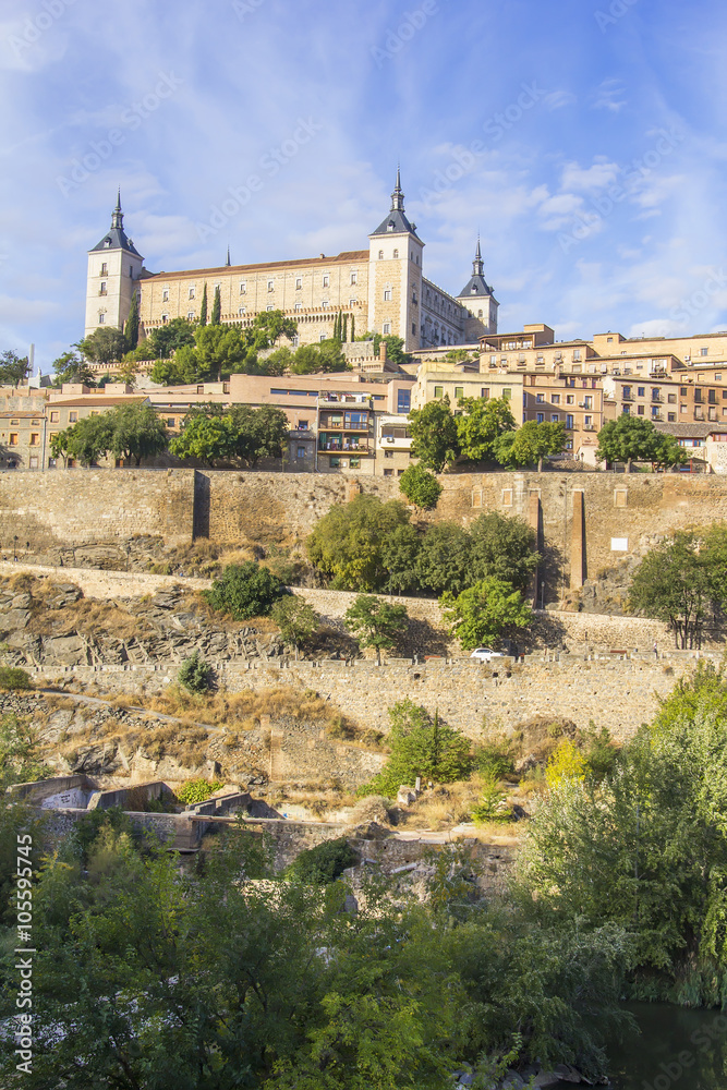 background landscape view of the walls of Toledo and Alcazar from the banks of the river Tagus, Castilla La Mancha, Spain