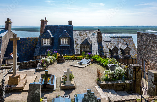 France, Normandy, the houses and cemetery of the medieval village of Mont St Michel