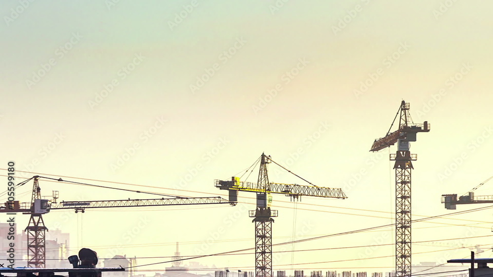 time lapse sunset and silhouette crane working in construction site time lapse sunset and silhouette crane working in construction site
