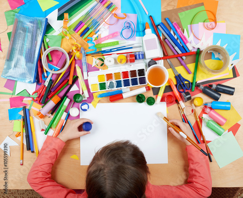 Child drawing top view. Artwork workplace with creative accessories. Flat lay art tools for painting.