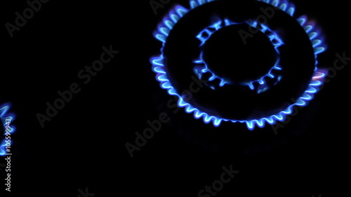 Moving around over kitchen gas stove with burners turned on