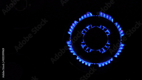 Natural gas inflammation from kitchen stove, dark shot, view from top