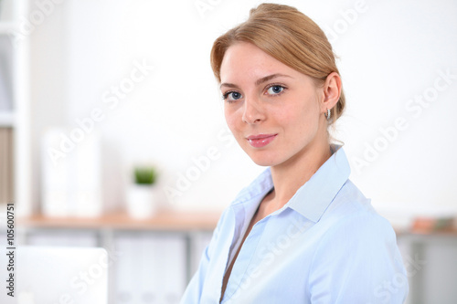 Young blonde business woman with laptop in the office. Business concept. Free Download Young blonde business woman with laptop in the office. Business concept. - GFXLoad