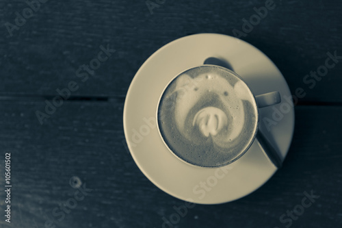 Vintage latte art with space on wooden tale background 