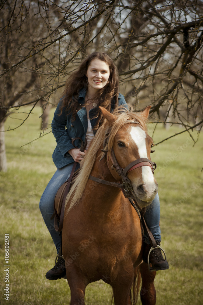 Fototapeta premium Happy woman riding her horse