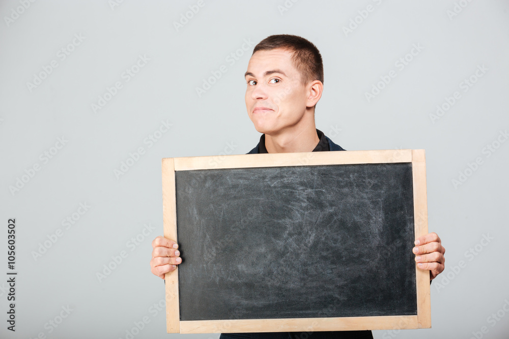 Happy businessman holding blank board