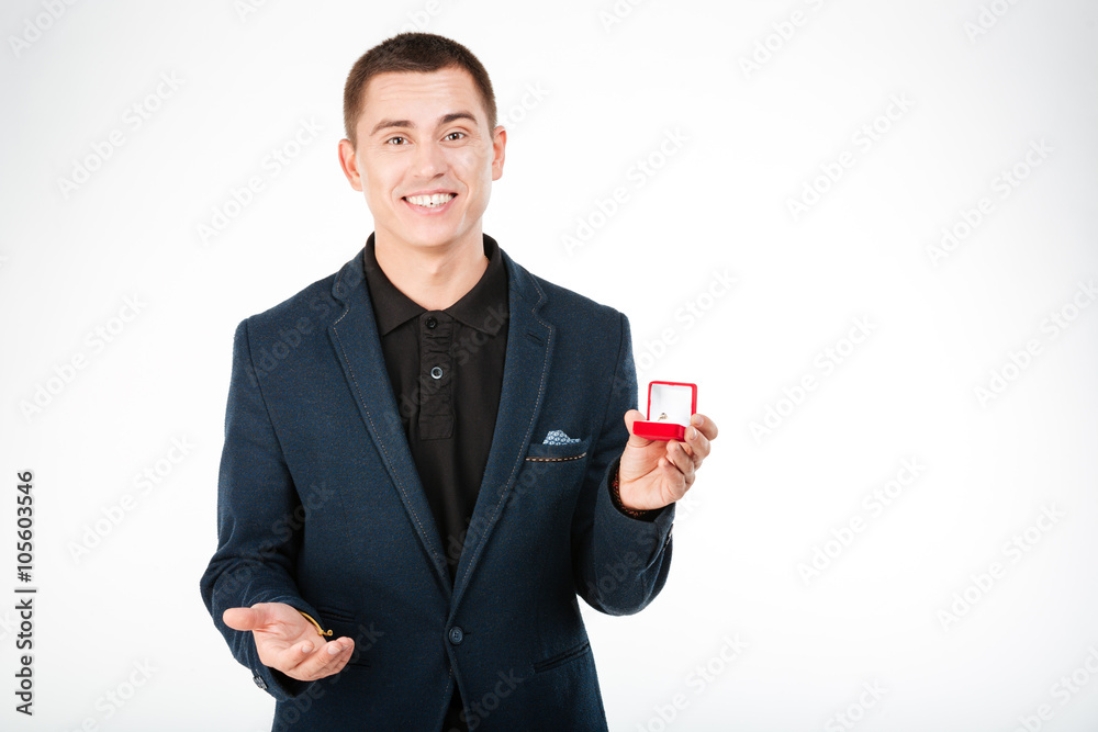 Happy businessman holding engagement ring Happy businessman holding engagement ring
