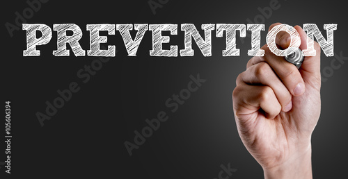 Hand writing the text: Prevention photo