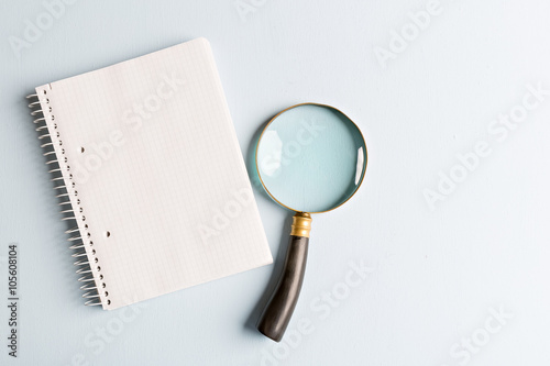 magnifier and notebook
